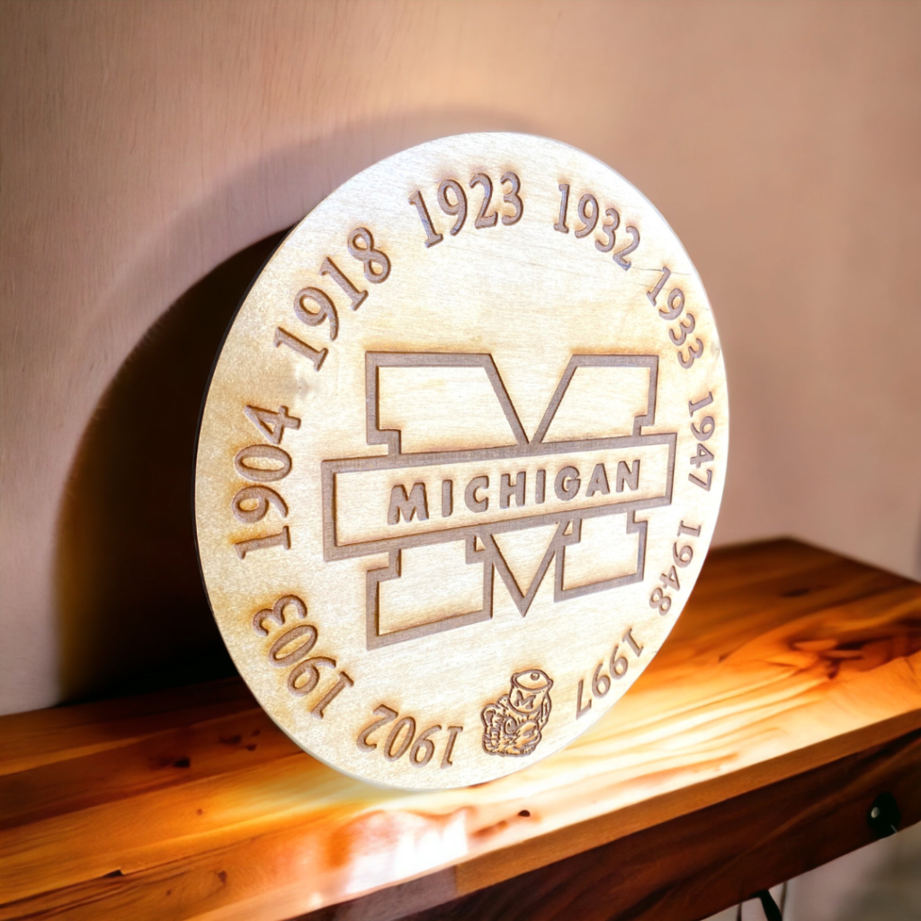 Custom wood engravings featuring sports team logos and names, by Creative Adventure Co.